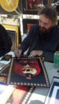 Stanley Mouse signing Bossman posters