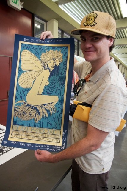 Fan showing off signed poster by Chuck Sperry